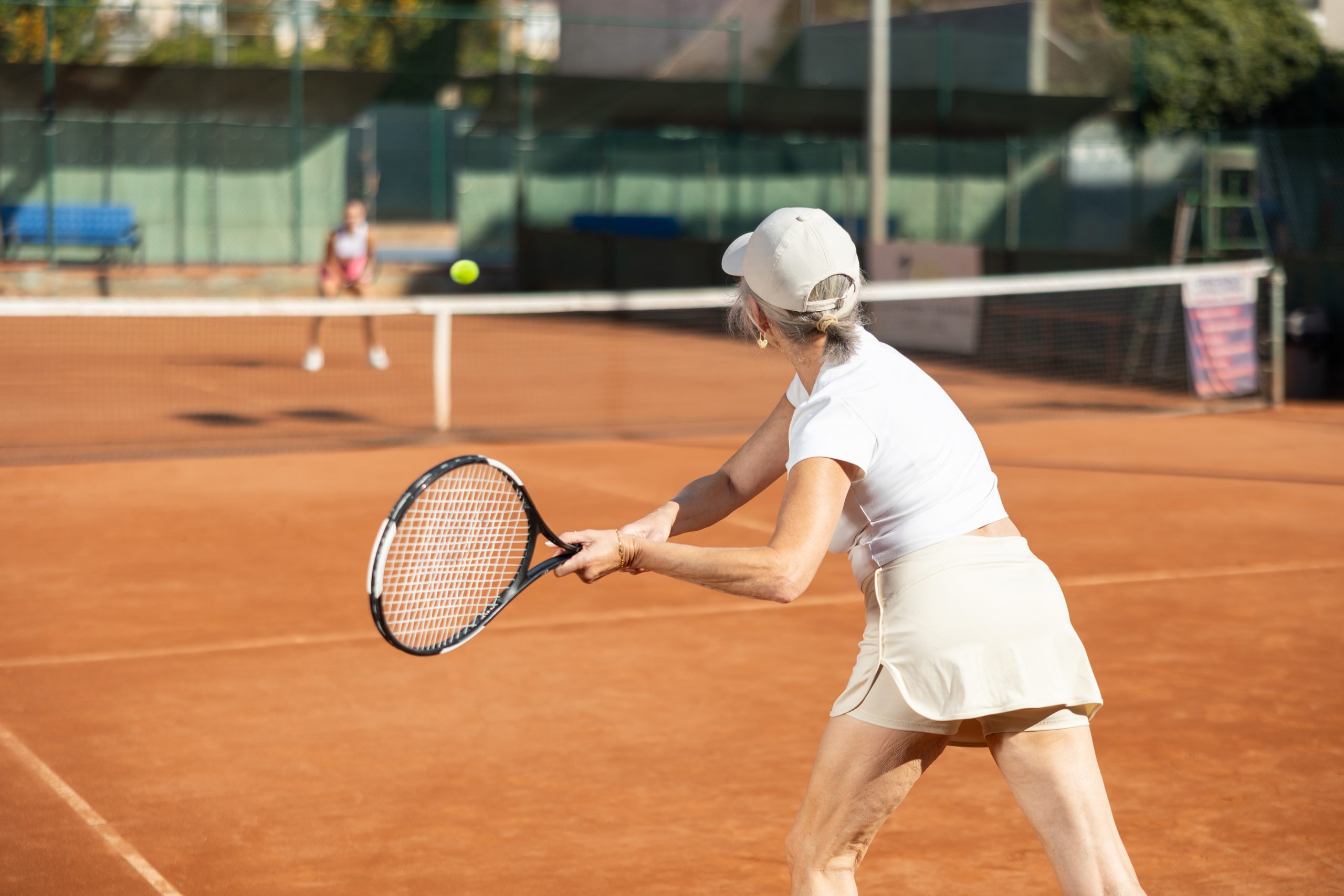 Active senior woman playing tennis